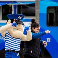 Louie dances with an alum next to a food truck